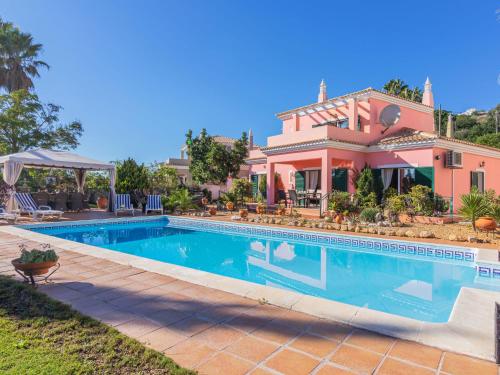 a house with a swimming pool in front of it at Villa Villa Rosa by Interhome in Loulé