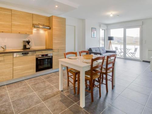 a kitchen with a table and chairs in a room at Apartment Le Clos Fontaine by Interhome in Saint Malo