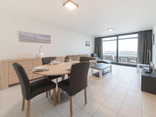 a dining room and living room with a table and chairs at Apartment Seaview 4 by Interhome in Bredene