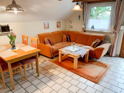 a living room with a couch and a table at Apartment Peters-2 by Interhome in Barkholt