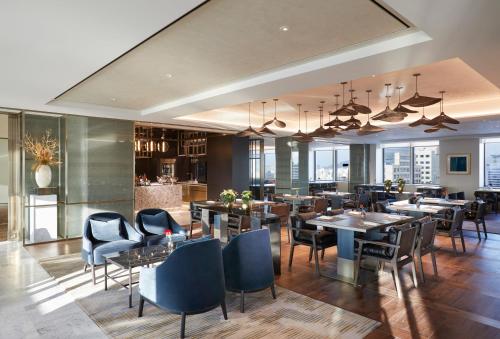 a restaurant with tables and chairs and a kitchen at Grand InterContinental Seoul Parnas by IHG in Seoul