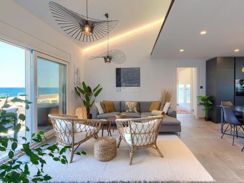 a living room with a couch and a table and chairs at Apartment Penthouse Mira by Interhome in Umag