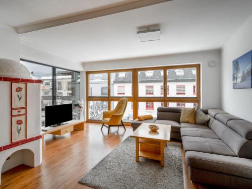 a living room with a couch and a tv at Apartment Papa Joe's Kuschelappartements-2 by Interhome in Schladming