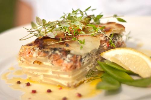 a piece of food on a plate with a lemon at Sunderby folkhögskola Hotell & Konferens in Luleå