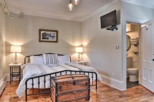 a bedroom with a bed with a wooden trunk at The Burrell House in Keene