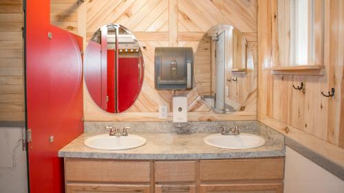 a bathroom with two sinks and two mirrors at FunStays Glamping Setup Tent in RV Park #4 OK-T4 in Moab