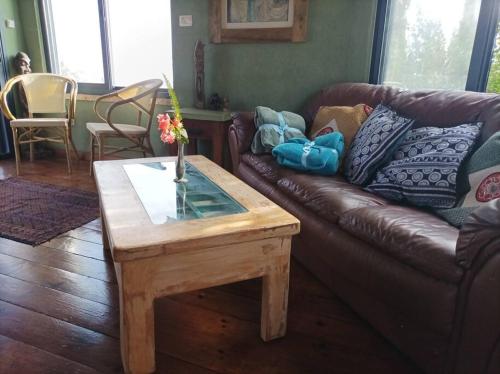 a living room with a leather couch and a coffee table at קטלב kta-love in Kammon