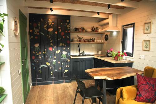 a kitchen with a table and a dining room at Шале DEREVA in Yablunytsya