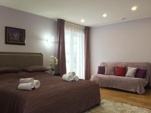 a bedroom with two beds and a couch at Radvi House in Druskininkai