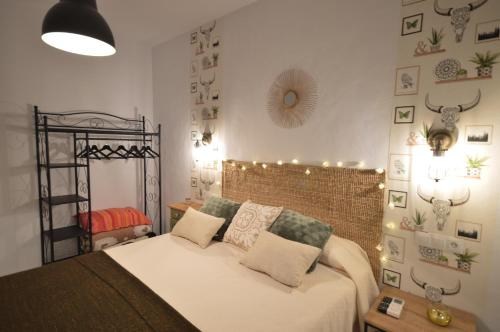 a bedroom with a bed with lights on the wall at Casa Molina in Alcaucín
