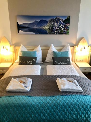 a bedroom with two beds with towels on them at Apartment Goisernperle in Bad Goisern