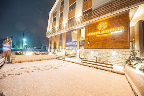 a building with a sign on the side of it at Modern Mountain - Apartment Najomi in Kolašin