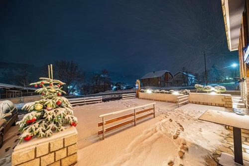 a christmas tree sitting on top of a building at Modern Mountain - Apartment Najomi in Kolašin