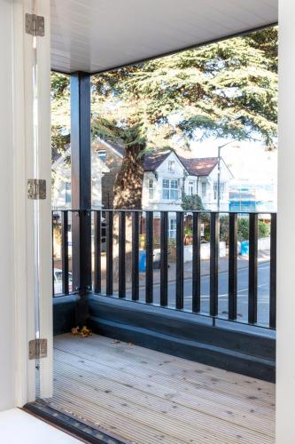 a giraffe standing on a porch looking out of a window at Hampden Apartments - The Anne in Windsor