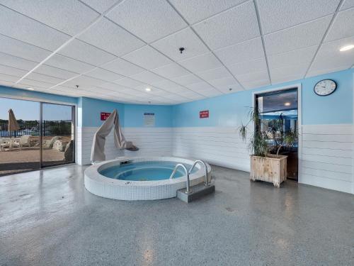 a large room with a jacuzzi tub in a building at 222 Edgewater Inn in Charlevoix
