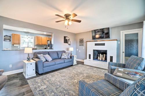 a living room with a couch and a fireplace at Table Rock Lake Home - Fire Pit and Lake Views! in Golden