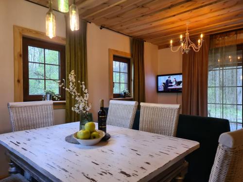 a dining room table with a bowl of fruit on it at Casa Del Campo 1 in Gaśno