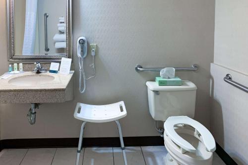 a bathroom with a toilet and a sink and a phone at Quality Inn near Toms River Corporate Park in Manchester Township