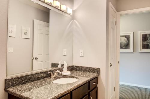 La salle de bains est pourvue d'un lavabo et d'un miroir. dans l'établissement Seacove 7E 2 Bedroom Condo, à Destin