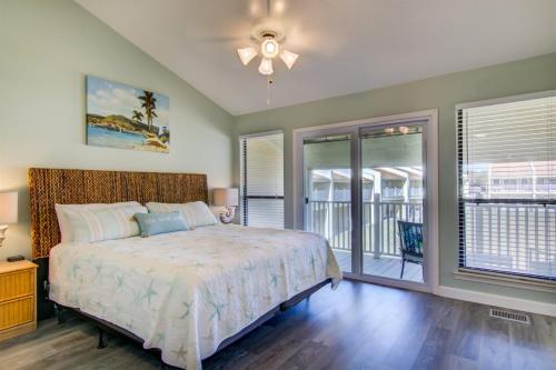 a bedroom with a bed and a balcony at 2 B, Three Bedroom Townhome in Destin