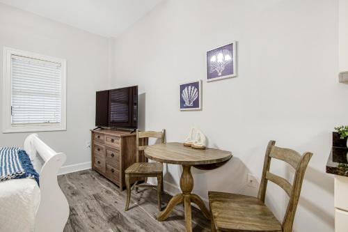 a room with a table and a tv and a bed at Village of South Walton CB 243 in Rosemary Beach