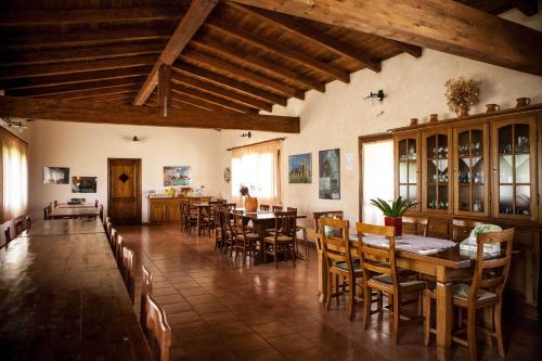 a dining room with wooden tables and chairs at Agriturismo Il Ginepro in Fluminimaggiore