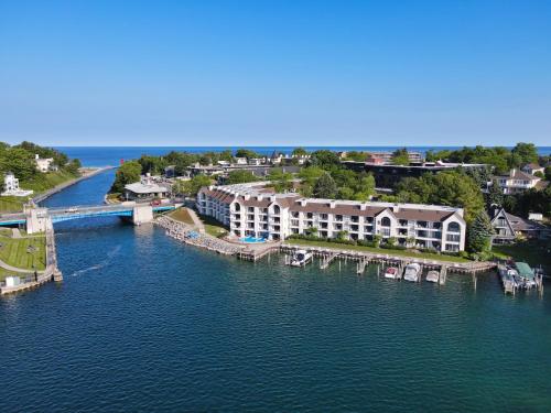 an aerial view of a river with buildings and a bridge at 341 Edgewater Inn in Charlevoix
