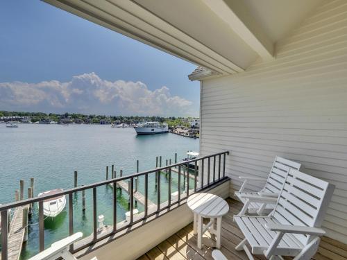two chairs on a porch with a view of the water at 343 Edgewater Inn in Charlevoix