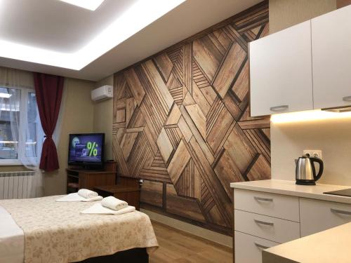 a room with a wall with a wooden accent wall at APARTHOTEL BON BON in Sofia