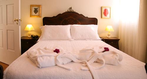 a bedroom with a bed with towels on it at Casa Manuel Espregueira e Oliveira in Viana do Castelo