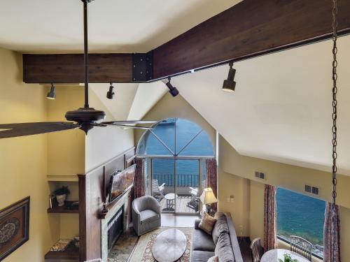 a living room with yellow walls and a large window at 354 Edgewater Inn in Charlevoix