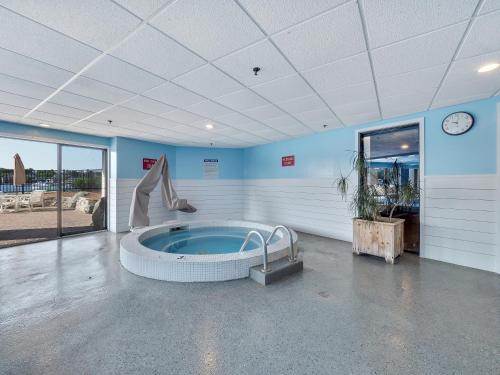 a large room with a jacuzzi tub in a building at 377 Edgewater Inn in Charlevoix