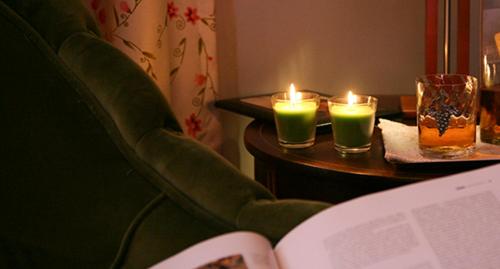 a table with a chair with candles and a book at Casa Manuel Espregueira e Oliveira in Viana do Castelo