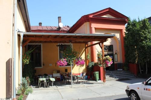 a house with a patio with tables and chairs at Hotel Corrado in Ostrava