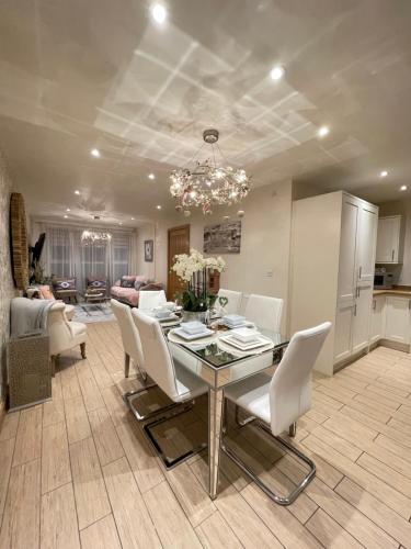 a dining room and living room with a table and chairs at Waterfront Villa Marina SA1 Swansea in Swansea