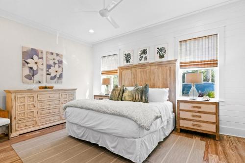 a bedroom with a bed and a dresser and windows at Family Tides in Santa Rosa Beach