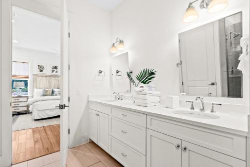 a white bathroom with a sink and a mirror at Family Tides in Santa Rosa Beach