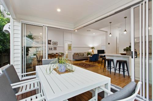 a kitchen and living room with a white table and chairs at Sierra Cottage - A Homely Space, Superb Location in Toowoomba