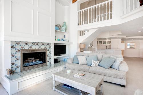 a living room with a couch and a fireplace at Sandcastle by the Sea in Oxnard