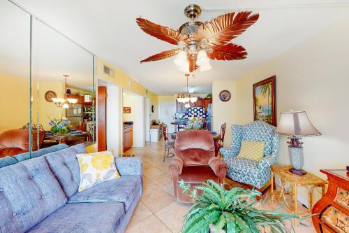 a living room with a blue couch and chairs at Plantation East #1104 in Gulf Highlands