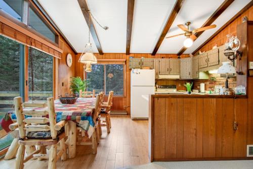 a kitchen and dining room with a table and chairs at Catfish Lake Home in Eagle River