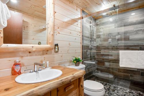 a bathroom with a sink and a shower at Catfish Lake Home in Eagle River