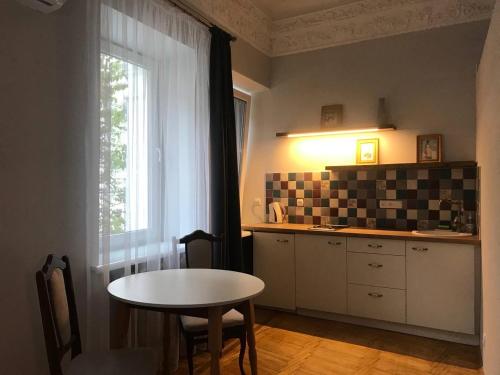 a kitchen with a table and a table and a window at Ermitage Apt, Апартаменти в Центрі Дніпра in Dnipro