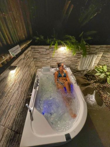 a woman sitting in a bath tub at Ecohotel Piedemonte in Salento