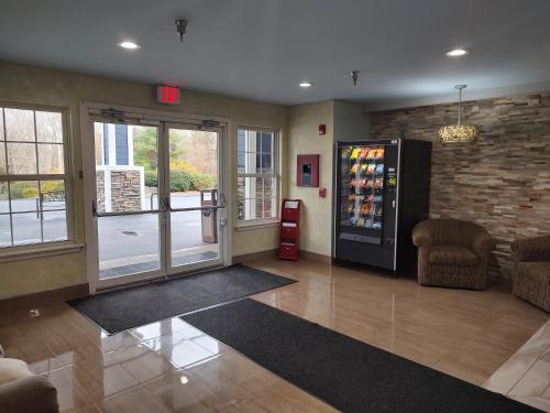 a lobby with a soda vending machine in a building at Hilltop Inn & Suites, near Foxwoods Casino in North Stonington