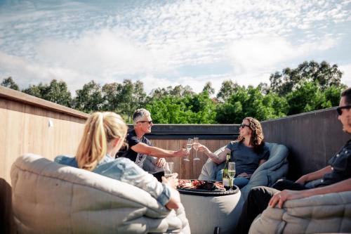 a group of people sitting around a table on a roof at BullerRoo in Barwite