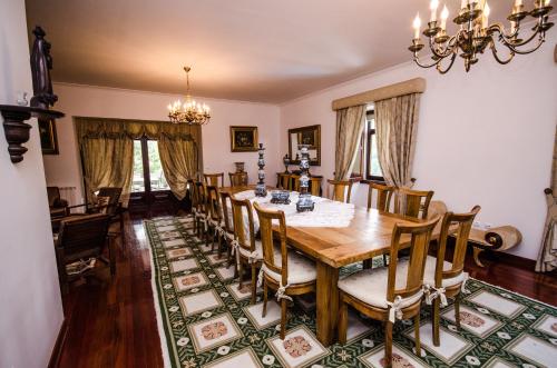 a dining room with a wooden table and chairs at Solar Quinta da Portela - Douro in Santa Marta de Penaguião