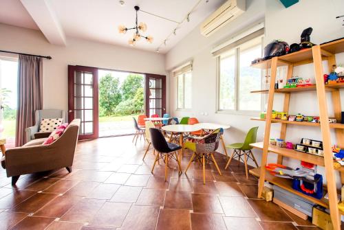 a living room with a table and chairs at Miinnon Village B&B in Meinong