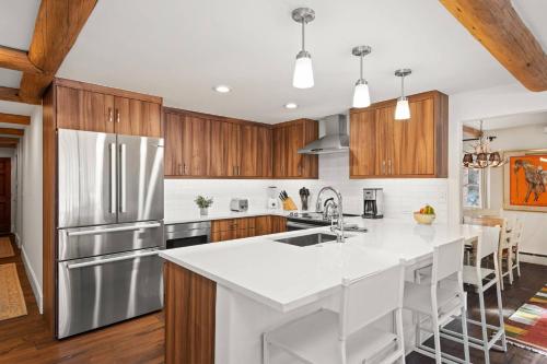 a kitchen with a white counter top and wooden cabinets at 700 Monarch 201 in Aspen
