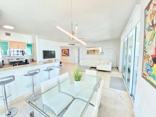 a living room with a glass table and chairs at The King David Condos in Miami Beach